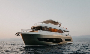 The custom-built luna trawler yacht navigating the turkish coast, featuring a robust full-displacement hull and classic maritime lines designed for long-range cruising.