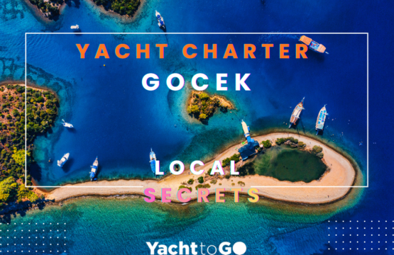 Luxury motor yacht and traditional wooden gulets anchored in the turquoise waters of gocek, turkey.
