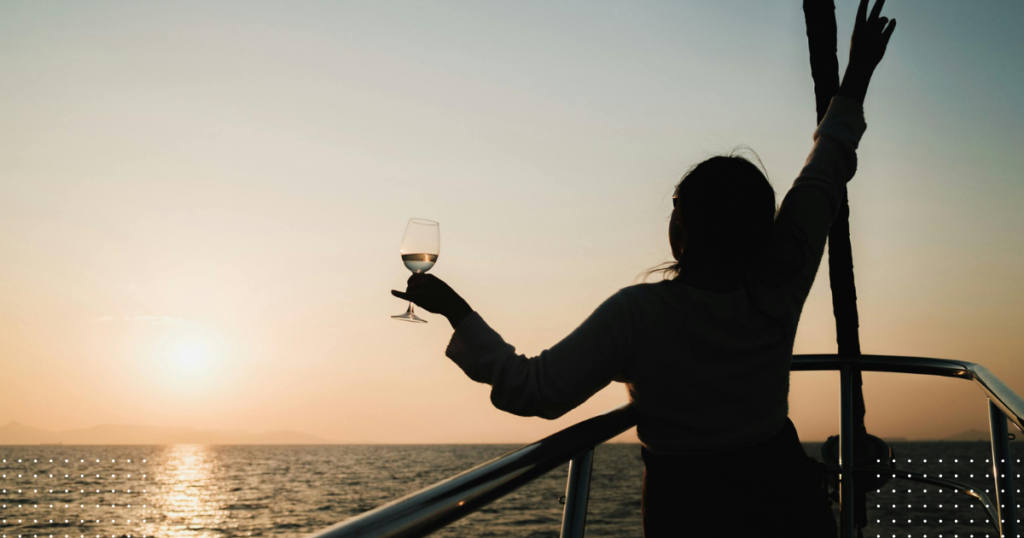 A sailboat navigating through dark waters, illustrating the severe safety risks of sailing drunk or at night. (note: if your actual image features specific details—like a person holding a drink at the helm or a stormy night—you can easily add that detail here).