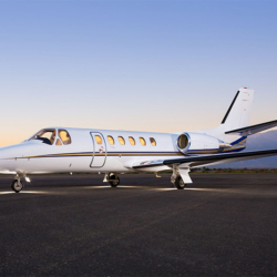Exterior view of the Cessna Citation Bravo light private jet waiting on the tarmac for a VIP charter flight.