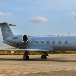 Exterior profile of the Gulfstream G4 heavy private jet parked on the tarmac ahead of a VIP charter flight.