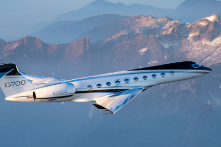 Exterior profile of the gulfstream g700 ultra-long-range private jet dominating the tarmac.