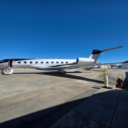 Exterior profile of the Gulfstream G700 ultra-long-range private jet dominating the tarmac.