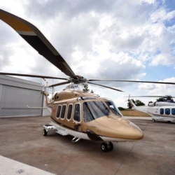 A VIP twin-engine helicopter flying over the Balearic Sea, executing a transfer from Ibiza to a superyacht anchored near Formentera.